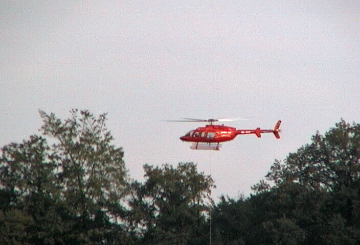 a helicopter transports building materials